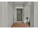 Inviting front door with brick-paved walkway and a friendly 'Hey Friends' sign at 9380 La Salle St, Groveland, FL 34736