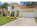 Charming two-story home with a well-manicured lawn, lush landscaping, and a two-car garage at 1055 Avenida Sonoma, Lady Lake, FL 32159