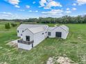 Beautiful modern exterior with metal roof, green lawn, and black trimmed windows and doors at 10711 County Road 561, Clermont, FL 34711