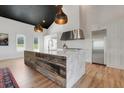 Modern kitchen featuring marble countertops, stainless steel appliances, and rustic wood island at 10711 County Road 561, Clermont, FL 34711
