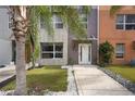 A modern townhome with a white front door, stone accents and a landscaped yard at 1603 Woodward St # 18, Orlando, FL 32803