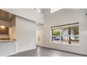 Open-concept living space with a high ceiling and an inviting view through the large window at 1603 Woodward St # 18, Orlando, FL 32803