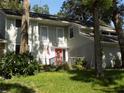 Charming two-story home with well-maintained lawn and a welcoming red door at 2108 Dogwood Cir, Mount Dora, FL 32757