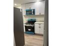 Bright kitchen featuring new appliances, white cabinetry, and granite countertops at 228 Cannon Way, Casselberry, FL 32707