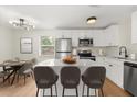 Modern eat-in kitchen featuring white cabinets, stainless steel appliances, and a large island at 2311 Vincent Rd, Orlando, FL 32817