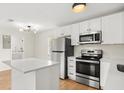 Contemporary kitchen featuring sleek countertops, stainless steel appliances, and ample cabinet space at 2311 Vincent Rd, Orlando, FL 32817
