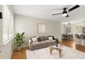 Bright living room with stylish furnishings, ceiling fan, and seamless open-concept design at 2311 Vincent Rd, Orlando, FL 32817