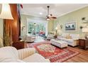 Comfortable living room featuring a ceiling fan, hardwood floors, and ample natural light at 2512 Baywater Rd, Tavares, FL 32778