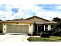 Charming single-story home with a well-maintained lawn, screened garage, and cozy front entrance at 327 Bentwood Dr, Leesburg, FL 34748