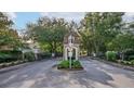Gated community entrance featuring stone pillars, a decorative tower and mature trees at 33441 Irongate Dr, Leesburg, FL 34788