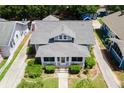 An aerial view of the charming bungalow with manicured lawn and a gray roof at 501 Washington Ave, Eustis, FL 32726