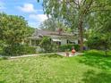 Exterior shot of the house with a well-maintained lawn and lovely landscaping at 504 Gilliam St, Wildwood, FL 34785