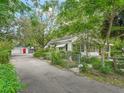 Exterior view of home with fenced yard, detached garage and mature landscaping at 504 Gilliam St, Wildwood, FL 34785