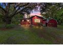 Charming single-story home featuring mature landscaping and a cozy covered porch at 54544 Buckhorn Rd, Astor, FL 32102