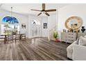 Bright, open-concept living area featuring hardwood floors, high ceilings, and abundant natural light at 5740 Bounty Cir, Tavares, FL 32778