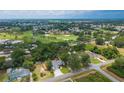 Expansive aerial view overlooking a golf course, surrounding greenery, and nearby neighborhood at 8160 Se 164Th Pl, Summerfield, FL 34491