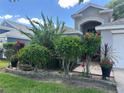 Home exterior with mature landscaping and a covered front entrance at 15509 Markham Dr, Clermont, FL 34714
