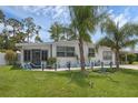 Charming home featuring a well-maintained lawn and decorative landscaping at 1025 Capella Dr, Tavares, FL 32778