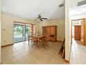 Dining room with tile flooring, ceiling fan, and view of the screened in back porch at 1053 Cavern Dr, Apopka, FL 32712