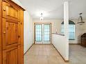 Bright foyer with tiled floor, white trim, and French doors leading outside at 1053 Cavern Dr, Apopka, FL 32712