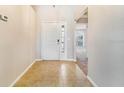 Inviting foyer with tile flooring and natural light streaming through the front door at 1055 Bluegrass Dr, Groveland, FL 34736