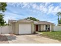 Charming single-story home featuring an attached one-car garage and beautiful landscaping at 1491 Providence Blvd, Deltona, FL 32725
