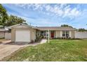 Charming single-story home featuring a well-manicured lawn, a light post and an attached one car garage at 1491 Providence Blvd, Deltona, FL 32725