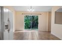 Bright dining area with a view of lush greenery through the sliding glass doors at 15925 Summit Ct, Clermont, FL 34711