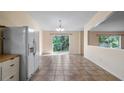 Bright dining area featuring sliding glass doors leading to the lush greenery outdoors at 15925 Summit Ct, Clermont, FL 34711
