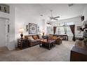 Comfortable living room with a ceiling fan, plush sofas, and large windows providing natural light and a relaxing atmosphere at 2265 Hackney Way, The Villages, FL 32162