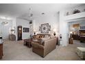 Inviting living room featuring neutral carpet, ceiling fan, and comfortable sofas creating a cozy and bright space at 2265 Hackney Way, The Villages, FL 32162