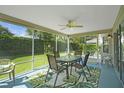 Screened-in lanai with a ceiling fan and comfortable outdoor seating, perfect for enjoying the Florida weather at 2369 Unity Ter, The Villages, FL 32162