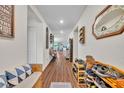 Inviting hallway with wood floors and decorative wall accents, leading to the main living areas at 2488 Begonia St, Mascotte, FL 34753