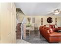 Inviting entryway and living room features a staircase, light walls, and a cozy seating arrangement at 2920 Poplar Ave, Leesburg, FL 34748