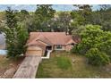 Aerial view of the home on a large lot surrounded by mature trees, showcasing its serene setting at 3184 Maltby Dr, Deltona, FL 32738