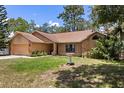 Charming single-story home featuring a brick facade, well-manicured lawn, and attached two-car garage at 3184 Maltby Dr, Deltona, FL 32738