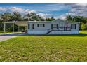 Charming single-story home with a covered carport and well-maintained lawn at 3359 County Road 513, Wildwood, FL 34785