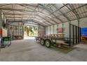Spacious garage interior with a trailer and ample room for storage or hobbies at 3359 County Road 513, Wildwood, FL 34785