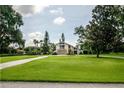 A large front yard leads to this charming home with lush landscaping and mature trees at 37138 Lake Yale Pl, Grand Island, FL 32735