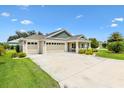 Charming single-story home featuring a well-manicured lawn and a three-car garage at 5311 Eads Ter, The Villages, FL 32163