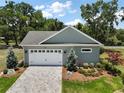 Aerial view of a well-maintained home featuring a two-car garage and a paved driveway at 622 W 11Th Ave, Mount Dora, FL 32757