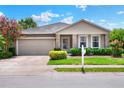 Charming single-story home featuring stone accents, landscaped front yard, and two-car garage at 6906 Glenbrook Dr, Lakeland, FL 33811