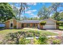 Charming single Gathering home with brick and siding, featuring a well-maintained front yard and attached garage at 7921 Sebago Ct, Orlando, FL 32835