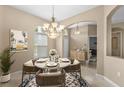 Cozy dining area featuring a round table with seating for four, chandelier, and a sunny window at 9413 Ivywood St, Clermont, FL 34711