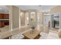 Inviting entryway with arched doorways, tile flooring, and views of the dining area and front door at 9413 Ivywood St, Clermont, FL 34711