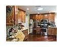 Wood cabinets and stainless appliances accent this kitchen's appeal for the cooking enthusiast at 1041 Reidville Rd, The Villages, FL 32162