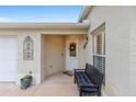 Inviting front porch featuring a bench, decorative features, and stylish design at 1065 Berg Ct, The Villages, FL 32162