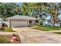 Attractive one-story home featuring an attached two-car garage and landscaped front yard at 1511 W Magnolia St, Clermont, FL 34711