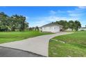 A well-maintained home on a large lot, featuring a long driveway leading to an attached garage at 15629 Catherine Cir, Groveland, FL 34736