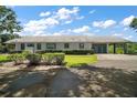 Charming single-story home with a porte cochere, complemented by mature landscaping and a well-maintained lawn at 16318, 16250 & 16300 County Road 448, Mount Dora, FL 32757